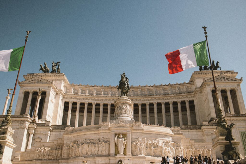 The iconic Vittorio Emanuele II Monument with Italian flags in Rome.